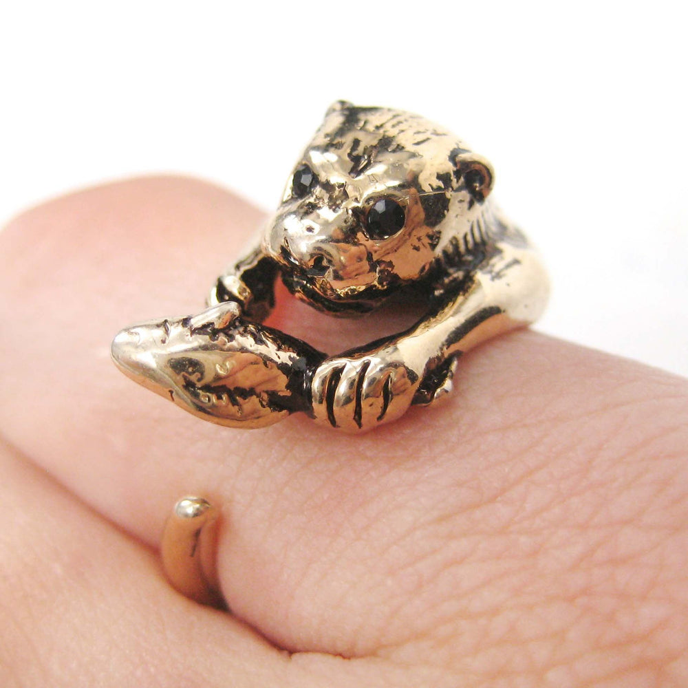 Otter Holding a Fish Shaped Animal Wrap Around Ring in Shiny Gold | US Sizes 4 to 9 | DOTOLY