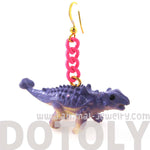 Scolosaurus Euoplocephalus Dinosaur Animal Figurine Shaped Dangle Earrings in Purple | DOTOLY
