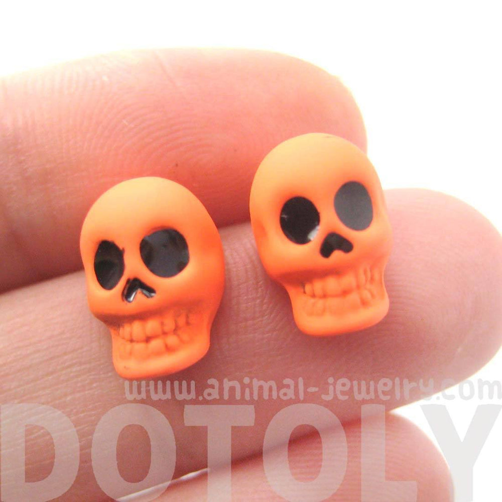 Unisex Skull Shaped Skeleton Themed Rocker Chic Stud Earrings in Neon Orange | DOTOLY