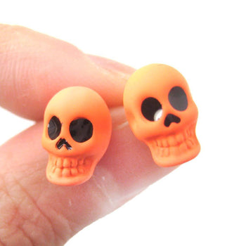 Unisex Skull Shaped Skeleton Themed Rocker Chic Stud Earrings in Neon Orange | DOTOLY