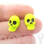 Unisex Skull Shaped Skeleton Themed Rocker Chic Stud Earrings in Neon Yellow | DOTOLY