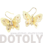 3D Butterfly Shaped Dangle Earrings in Gold With Floral Cut Out Details | DOTOLY | DOTOLY
