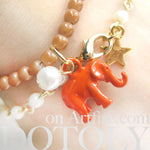 elephant-charm-animal-stretchy-bracelet-in-bright-orange-on-brown