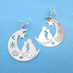 Cats on a Crescent Moon Cut Out Silhouette Shaped Dangle Earrings in Silver | Animal Jewelry | DOTOLY