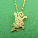 Dangling Cheeky Monkey With A Banana Shaped Pendant Necklace in Gold | DOTOLY