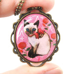 Fancy Siamese Kitty Cat Shaped Illustrated Oval Pendant Necklace in Pink with Bows and Roses | DOTOLY