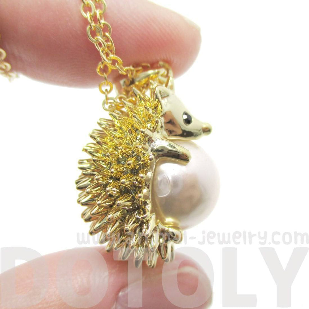Hedgehog Porcupine Hugging a Pearl Shaped Animal Pendant Necklace in Gold | DOTOLY