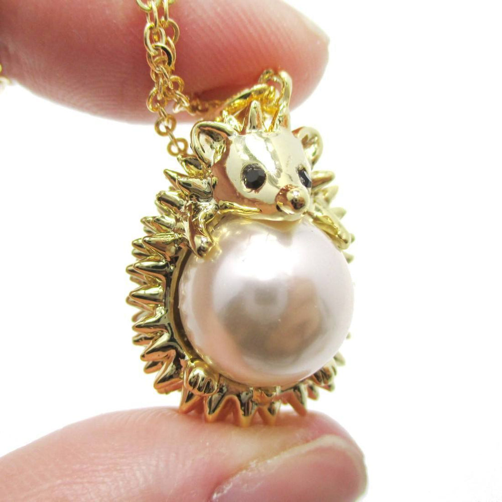Hedgehog Porcupine Hugging a Pearl Shaped Animal Pendant Necklace in Gold | DOTOLY