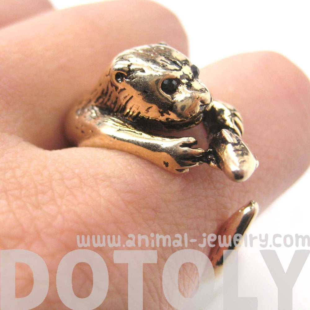 Otter Holding a Fish Shaped Animal Wrap Around Ring in Shiny Gold | US Sizes 4 to 9 | DOTOLY