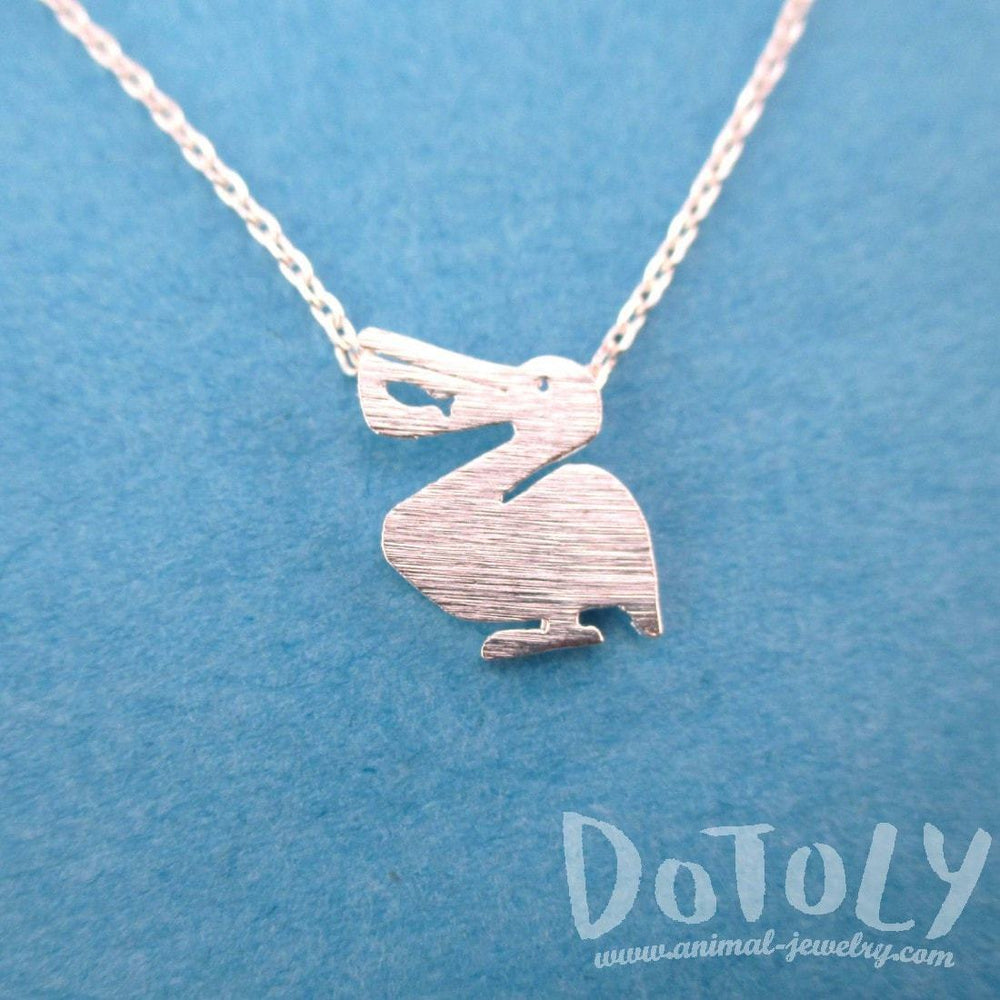 Pelican Silhouette with Fish Cut Out Shaped Charm Necklace in Silver | DOTOLY | DOTOLY