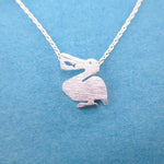 Pelican Silhouette with Fish Cut Out Shaped Charm Necklace in Silver | DOTOLY | DOTOLY