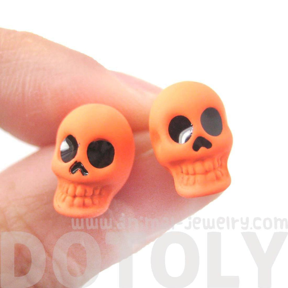 Unisex Skull Shaped Skeleton Themed Rocker Chic Stud Earrings in Neon Orange | DOTOLY